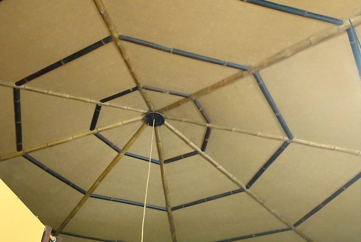 Interior ceiling with a bamboo spoke framework forming a geometric, tent-like dome